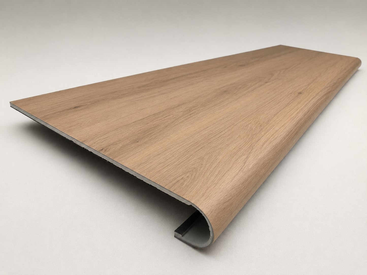 Custom round-nose stair tread made to match LifeProof Westminster Oak flooring. Round profile. Angled view.
