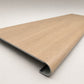 Custom round-nose stair tread made to match NuCore Caracal Crossing flooring. Round profile. Angled view.