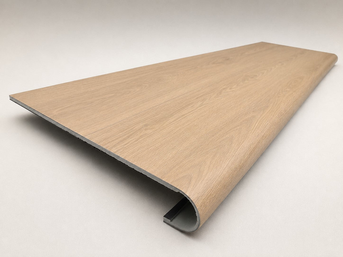 Custom round-nose stair tread made to match NuCore Caracal Crossing flooring. Round profile. Angled view.