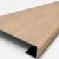 Custom square-nose stair tread made to match NuCore Caracal Crossing flooring. Square profile. Angled view.