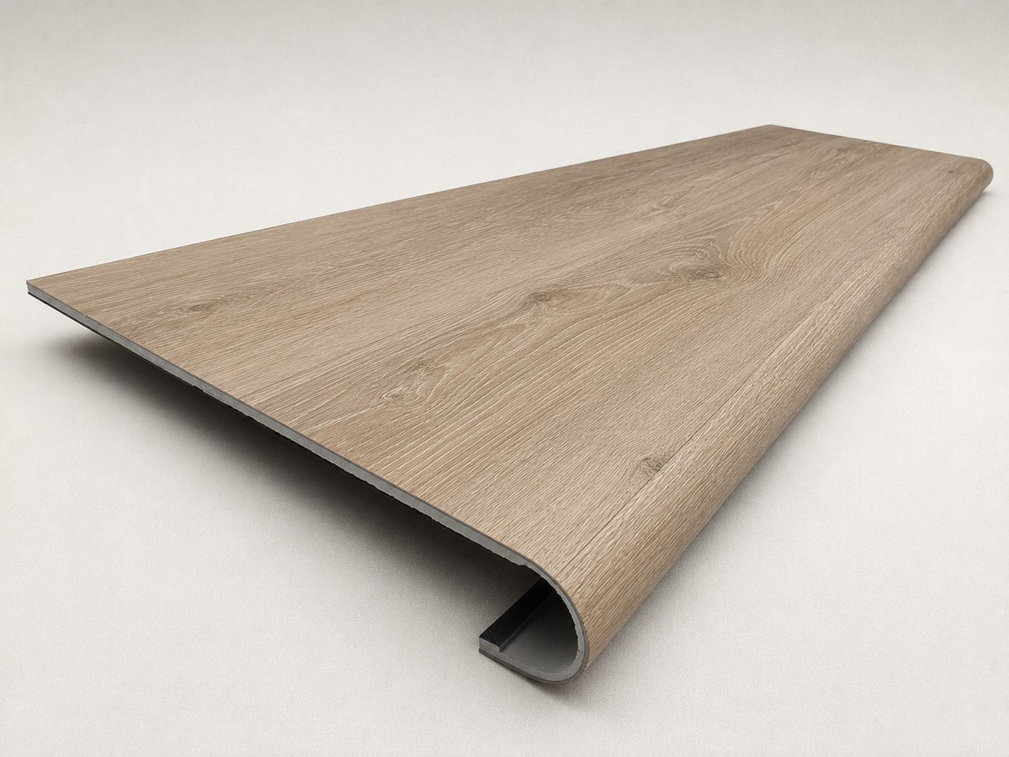 Custom round-nose stair tread made to match NuCore Deerfield Grove flooring. Round profile. Angled view.