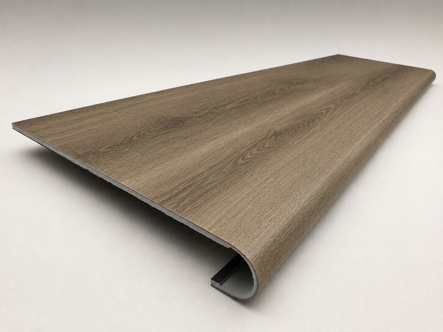 Custom round-nose stair tread made from NuCore Everwood Falls flooring. Round profile. Angled view.