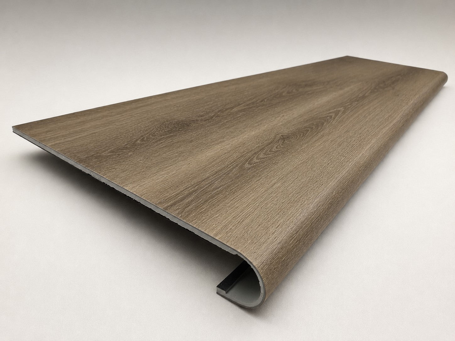 Custom round-nose stair tread made from NuCore Everwood Falls flooring. Round profile. Angled view.