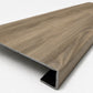Custom square-nose stair tread made from NuCore Everwood Falls flooring. Square profile. Angled view.