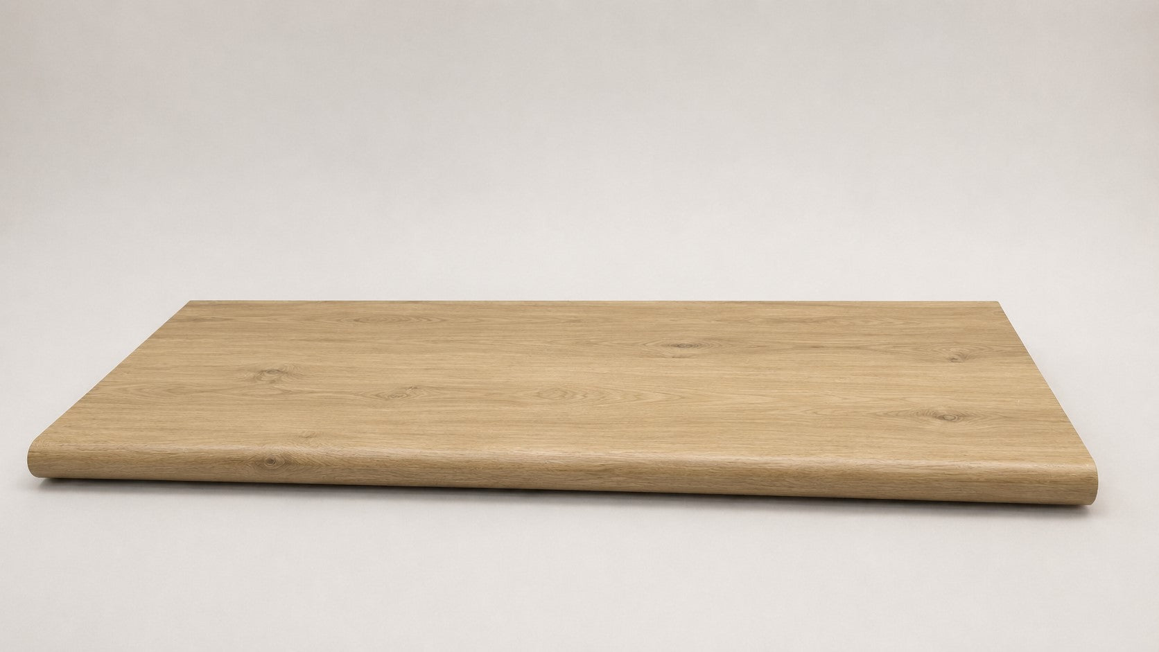 Custom round-nose stair tread made to match NuCore Fairborn Blonde flooring. Round profile. Full view.