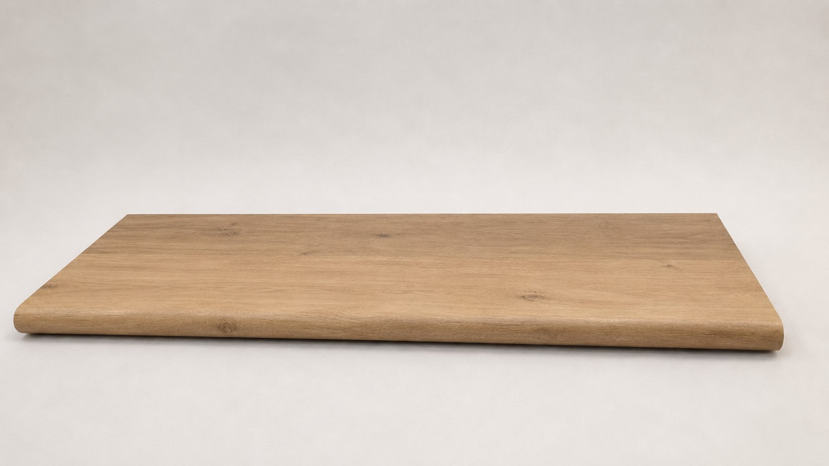Custom round-nose stair tread made from NuCore Glenridge Oak flooring. Round profile. Full view.