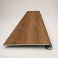 Custom round-nose stair tread made from NuCore Gunstock Oak flooring. Round profile. Front view.