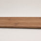 Custom round-nose stair tread made from NuCore Gunstock Oak flooring. Round profile. Full view.