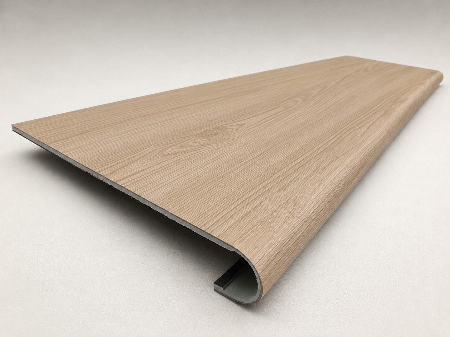 Custom round-nose stair tread made from NuCore Nordic Oak flooring. Round profile. Angled view.