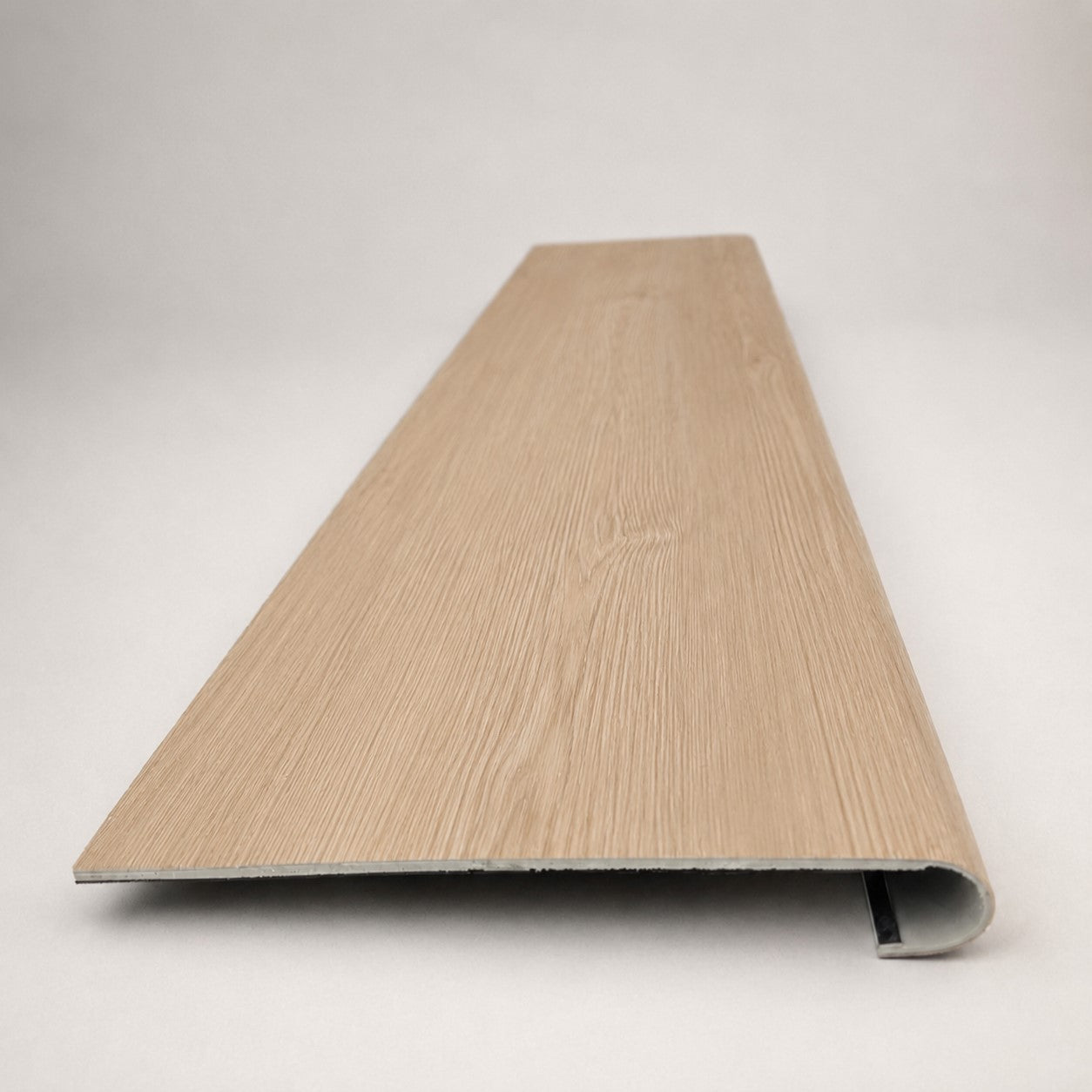 Custom round-nose stair tread made from NuCore Nordic Oak flooring. Round profile. Front view.