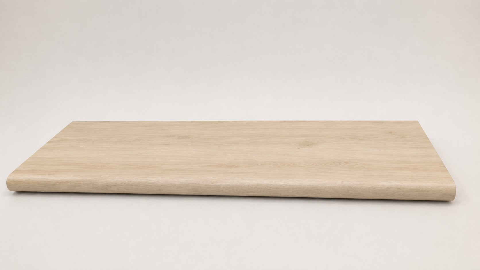 Custom round nose stair tread made from NuCore Nordic Oak flooring, showing a finished matching tread with light wood grain, smooth rounded profile, and professional product detail- Full view
