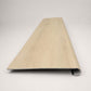 Custom round nose stair tread made from NuCore Nordic Oak flooring, showing a finished matching tread with light wood grain, smooth rounded profile, and professional product detail. Front View