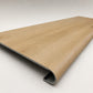 Custom round-nose stair tread made from NuCore Oakleigh Blonde flooring. Round profile. Angled view.