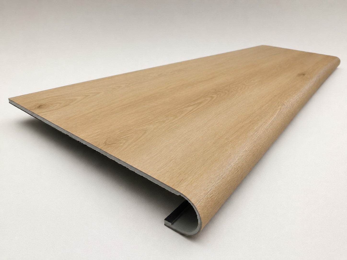 Custom round-nose stair tread made from NuCore Oakleigh Blonde flooring. Round profile. Angled view.