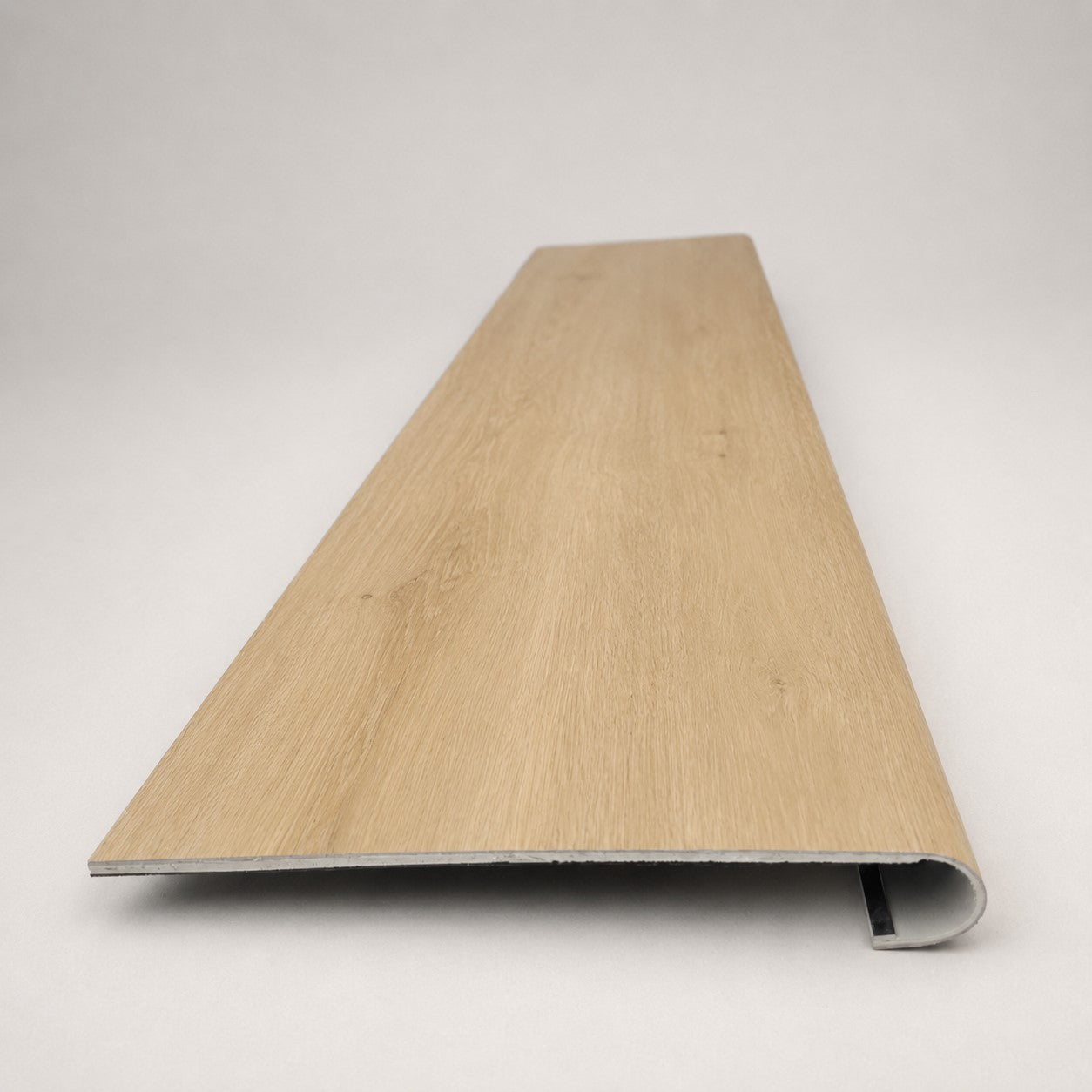 Custom round-nose stair tread made from NuCore Oakleigh Blonde flooring. Round profile. Front view.
