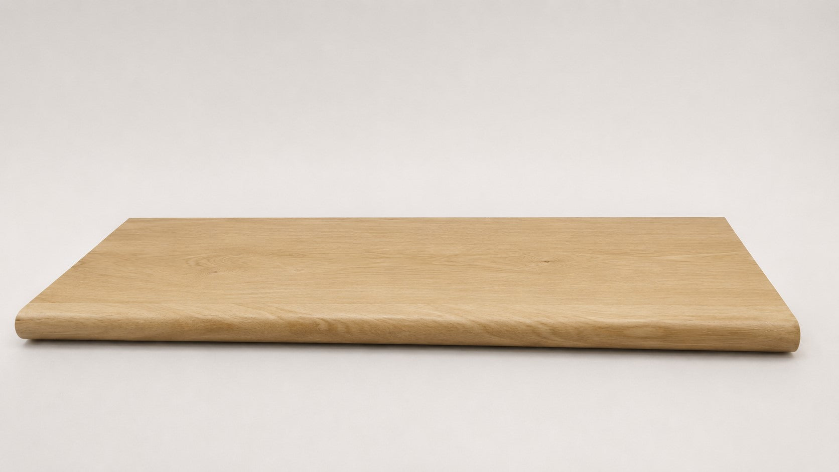 Custom round-nose stair tread made from NuCore Oakleigh Blonde flooring. Round profile. Full view.