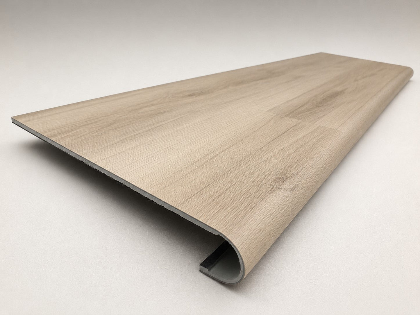 Custom round-nose stair tread made to match NuCore Turner Road flooring. Round profile. Angled view.