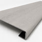 Custom square-nose stair tread made from NuCore Wisteria flooring. Square profile. Angled view.