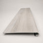 Custom round-nose stair tread made from STAINMASTER Port Isabel flooring. Round profile. Front view.