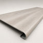 Custom round-nose stair tread made from STAINMASTER Sanderling Spruce flooring. Round profile. Angled view.