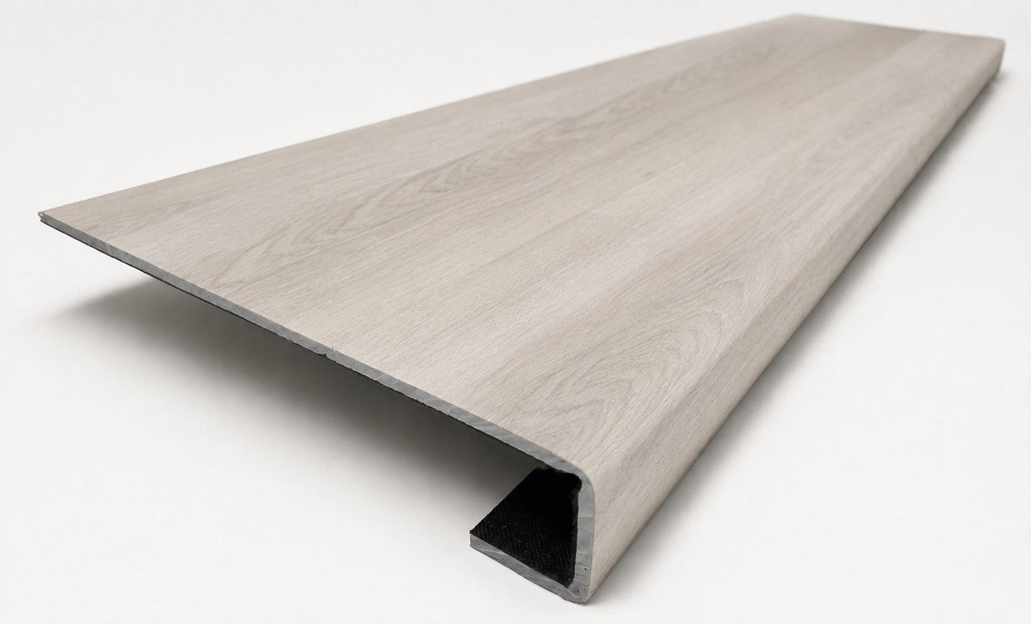 Custom square-nose stair tread made from STAINMASTER Sanderling Spruce flooring. Square profile. Angled view.