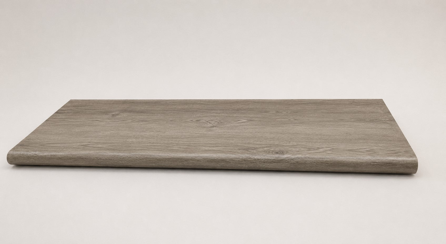 Custom round-nose stair tread made from Style Selections Ashen Oak flooring. Round profile. Full view.