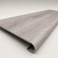 Custom round-nose stair tread made from Style Selections Charleston Oak flooring. Round profile. Angled view.