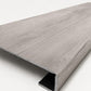 Custom square-nose stair tread made from Style Selections Charleston Oak flooring. Square profile. Angled view.
