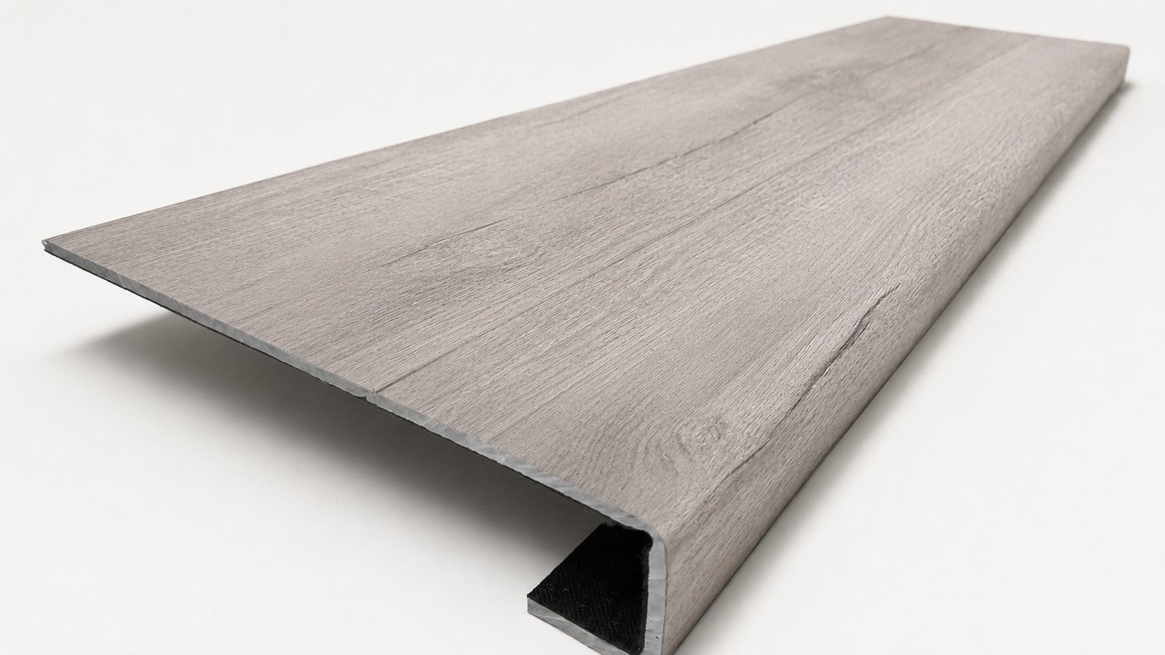 Custom square-nose stair tread made from Style Selections Charleston Oak flooring. Square profile. Angled view.
