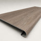 Custom round-nose stair tread made from Style Selections Dove Tail Oak flooring. Round profile. Angled view.