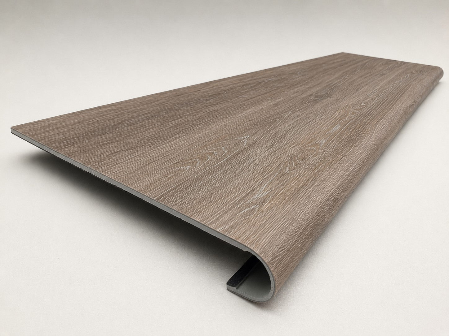 Custom round-nose stair tread made from Style Selections Dove Tail Oak flooring. Round profile. Angled view.
