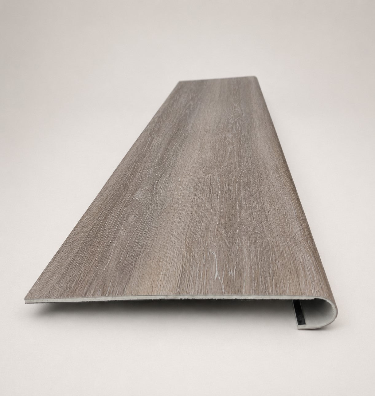 Custom round-nose stair tread made from Style Selections Dove Tail Oak flooring. Round profile. Front view.