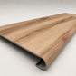 Custom round-nose stair tread made from Style Selections Jamestown Hickory flooring. Round profile. Angled view