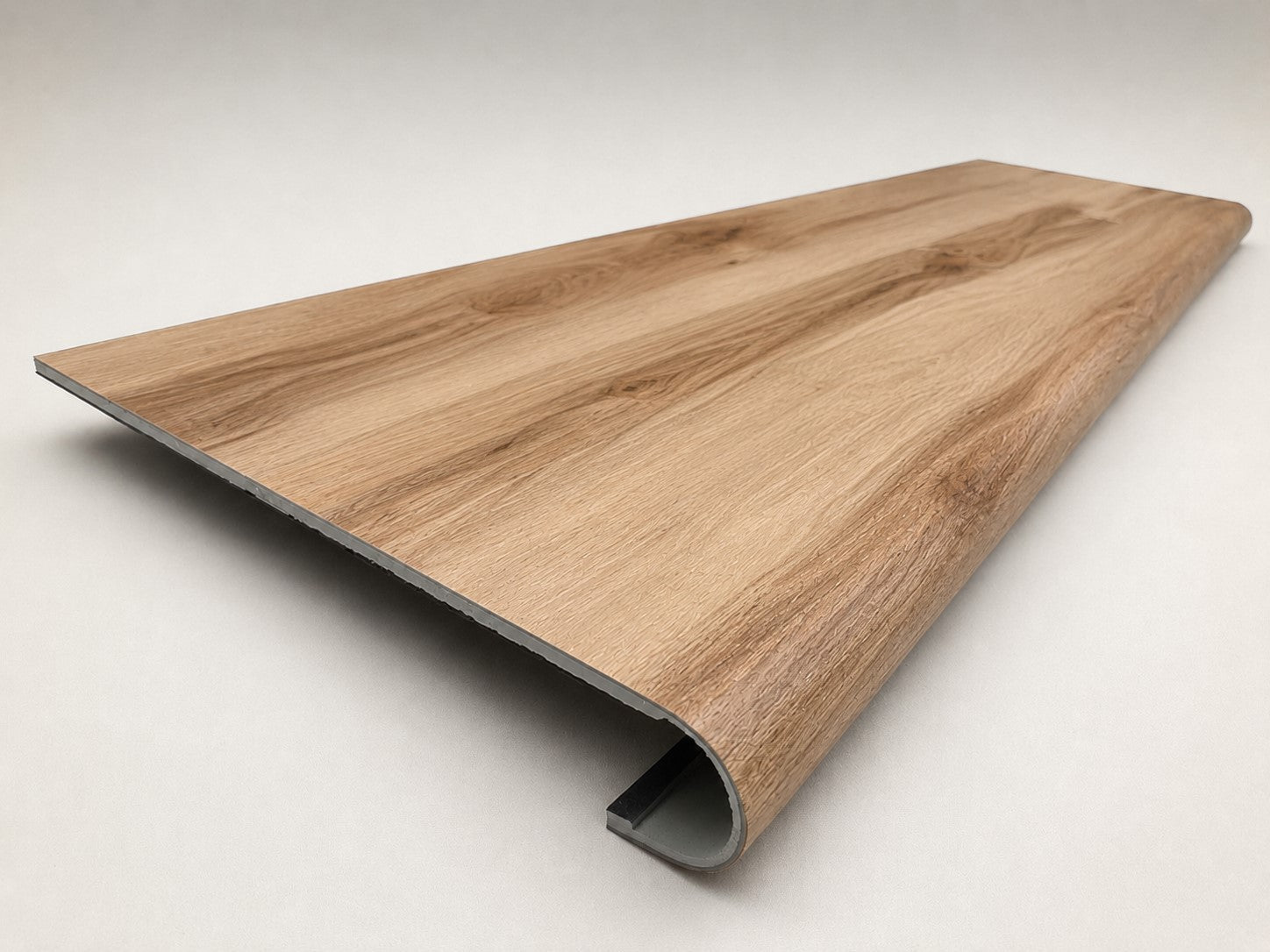 Custom round-nose stair tread made from Style Selections Jamestown Hickory flooring. Round profile. Angled view