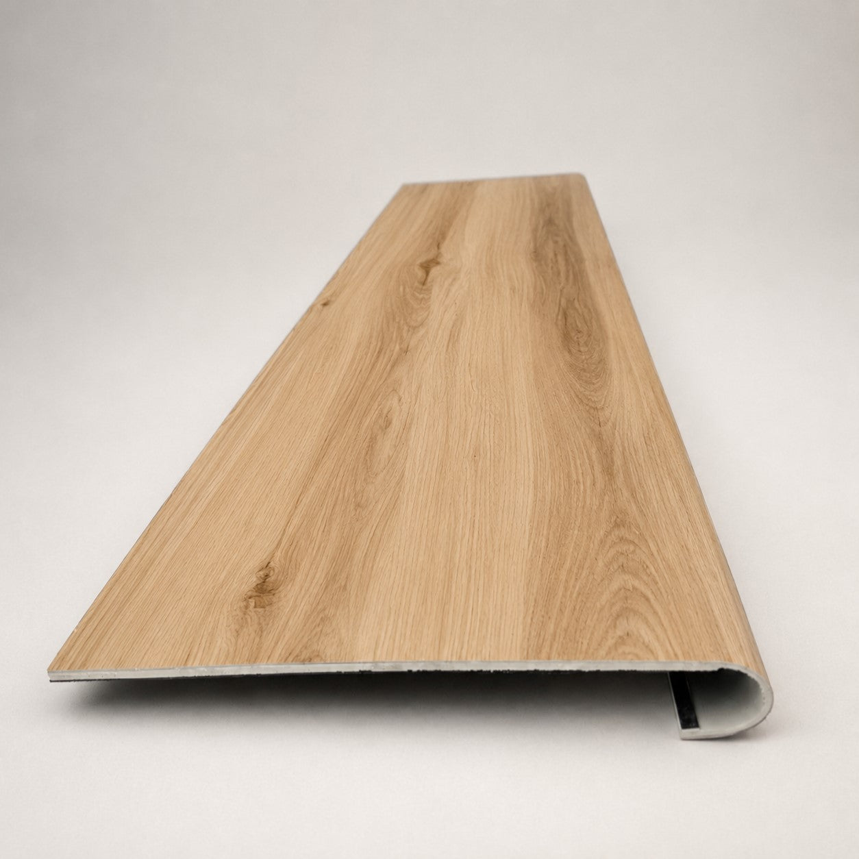 Custom round-nose stair tread made from Style Selections Jamestown Hickory flooring. Round profile. Front view.