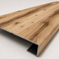 Custom square nose stair tread made from Style Selections Jamestown Hickory flooring, with a continuous matching wood-look profile. Angled View 