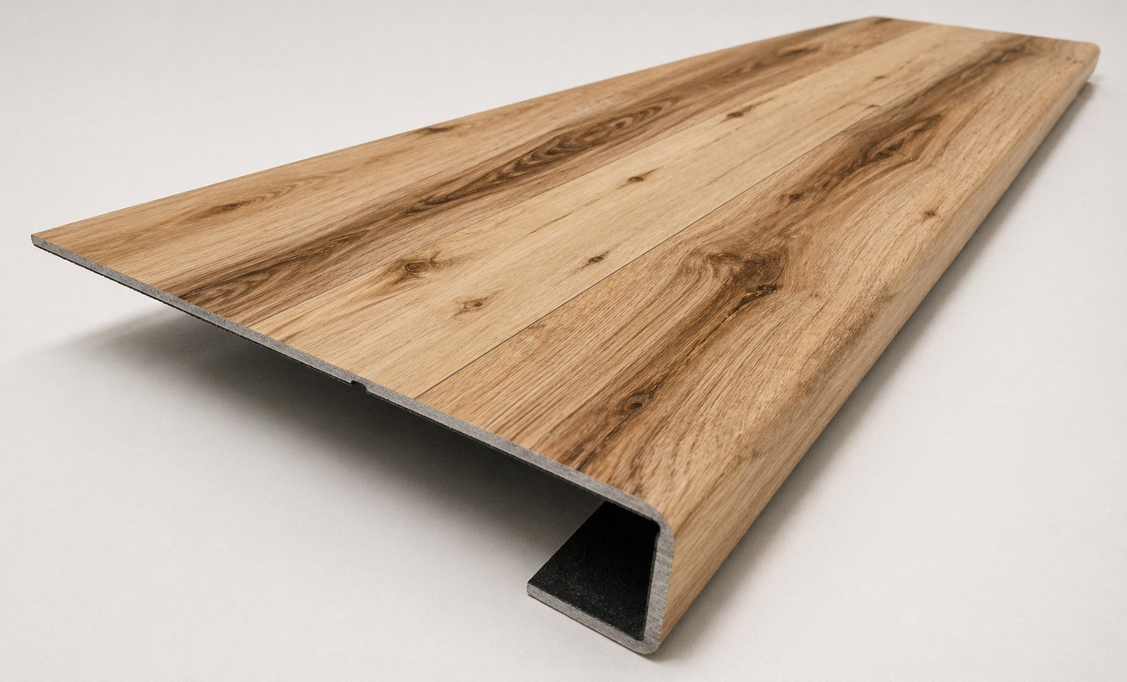 Custom square nose stair tread made from Style Selections Jamestown Hickory flooring, with a continuous matching wood-look profile. Angled View 