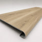 Custom round-nose stair tread made from Style Selections Natural Hickory flooring. Round profile. Angled view.