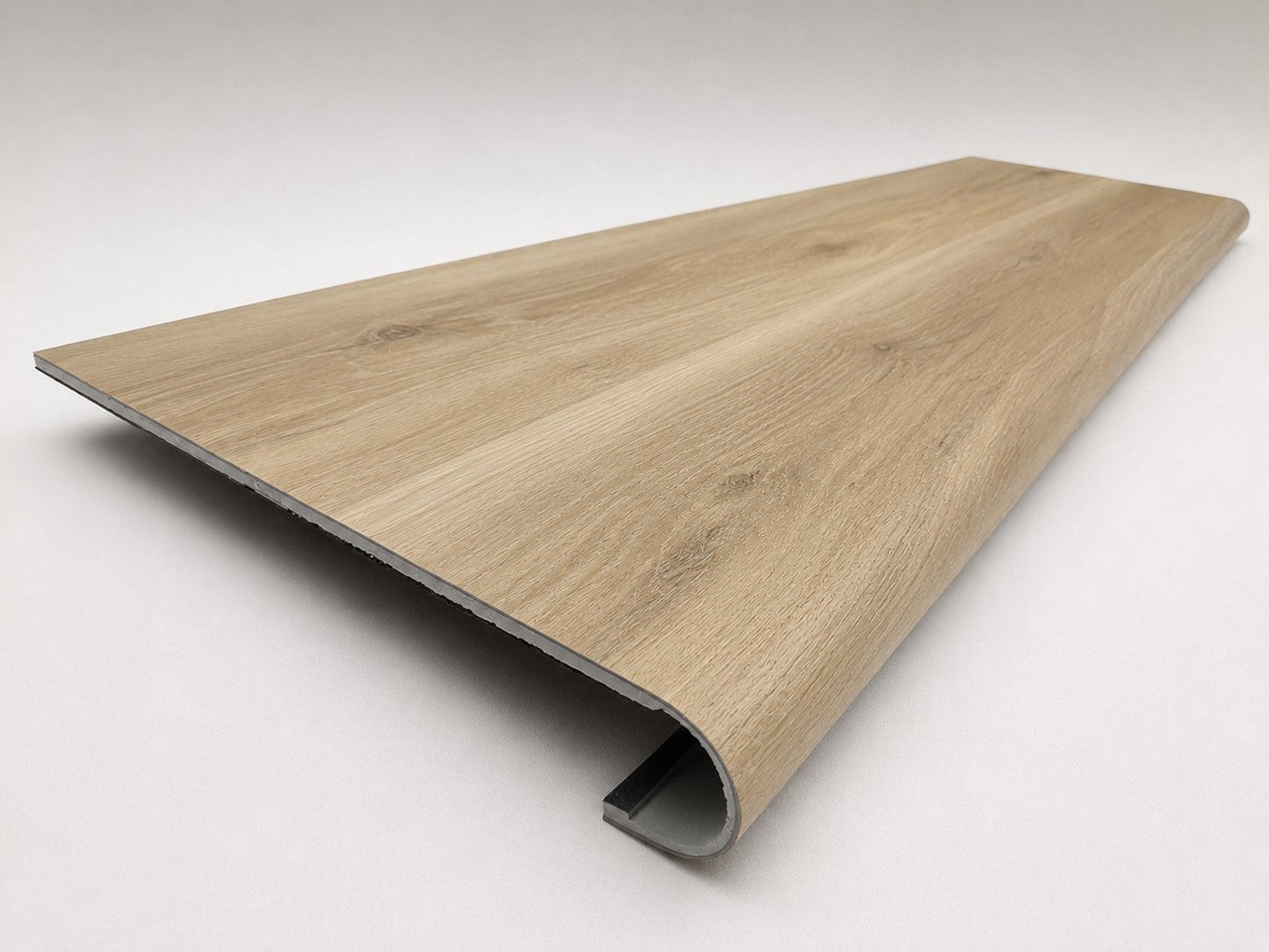 Custom round-nose stair tread made from Style Selections Natural Hickory flooring. Round profile. Angled view.