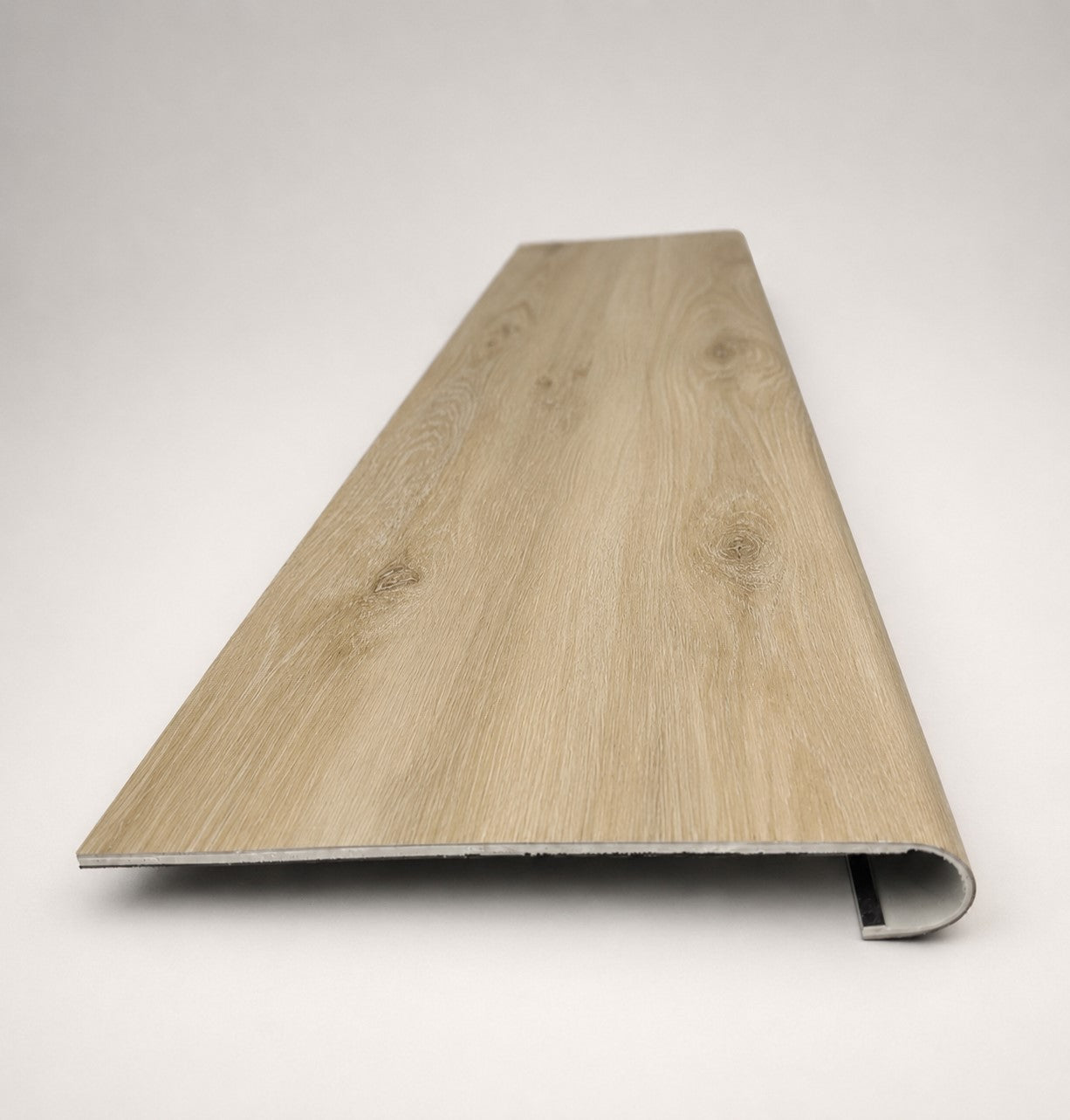 Custom round-nose stair tread made from Style Selections Natural Hickory flooring. Round profile. Front view.
