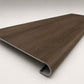 Custom round-nose stair tread made from Style Selections Tudor Oak flooring. Round profile. Angled view.