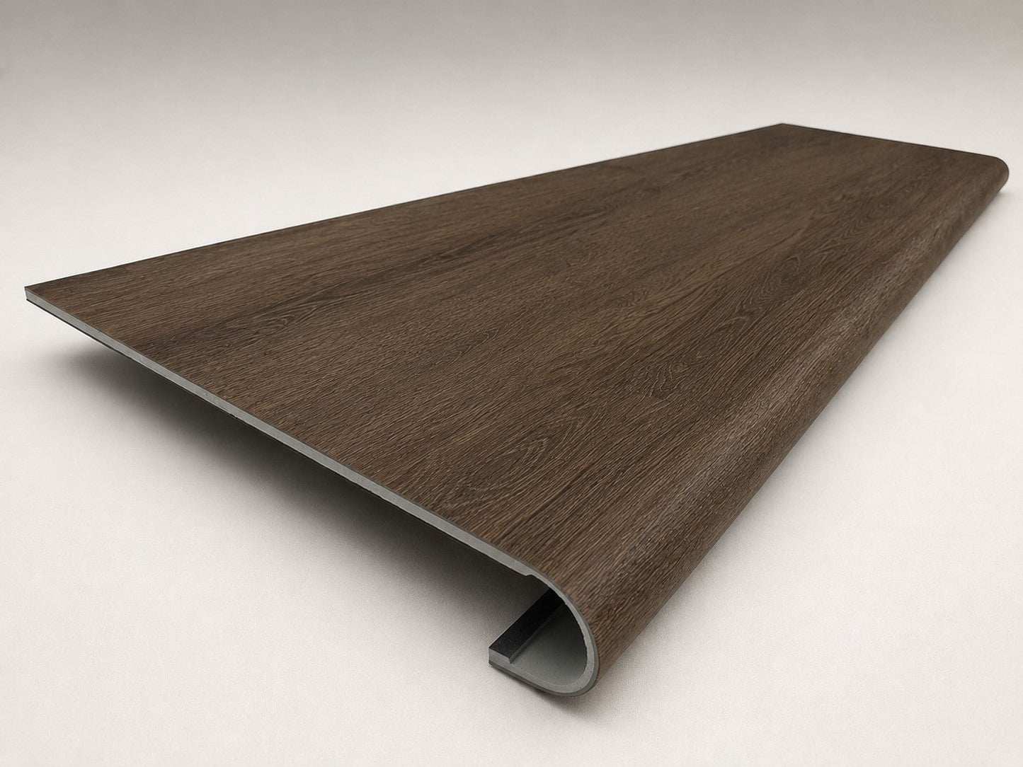 Custom round-nose stair tread made from Style Selections Tudor Oak flooring. Round profile. Angled view.
