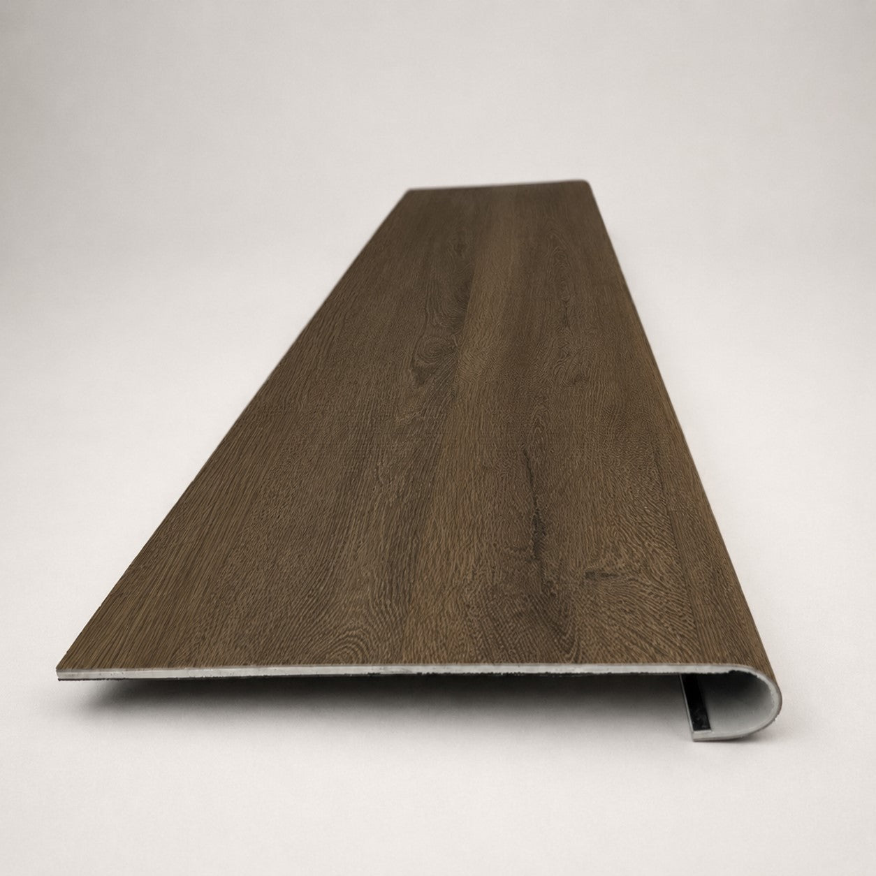 Custom round-nose stair tread made from Style Selections Tudor Oak flooring. Round profile. Front view.