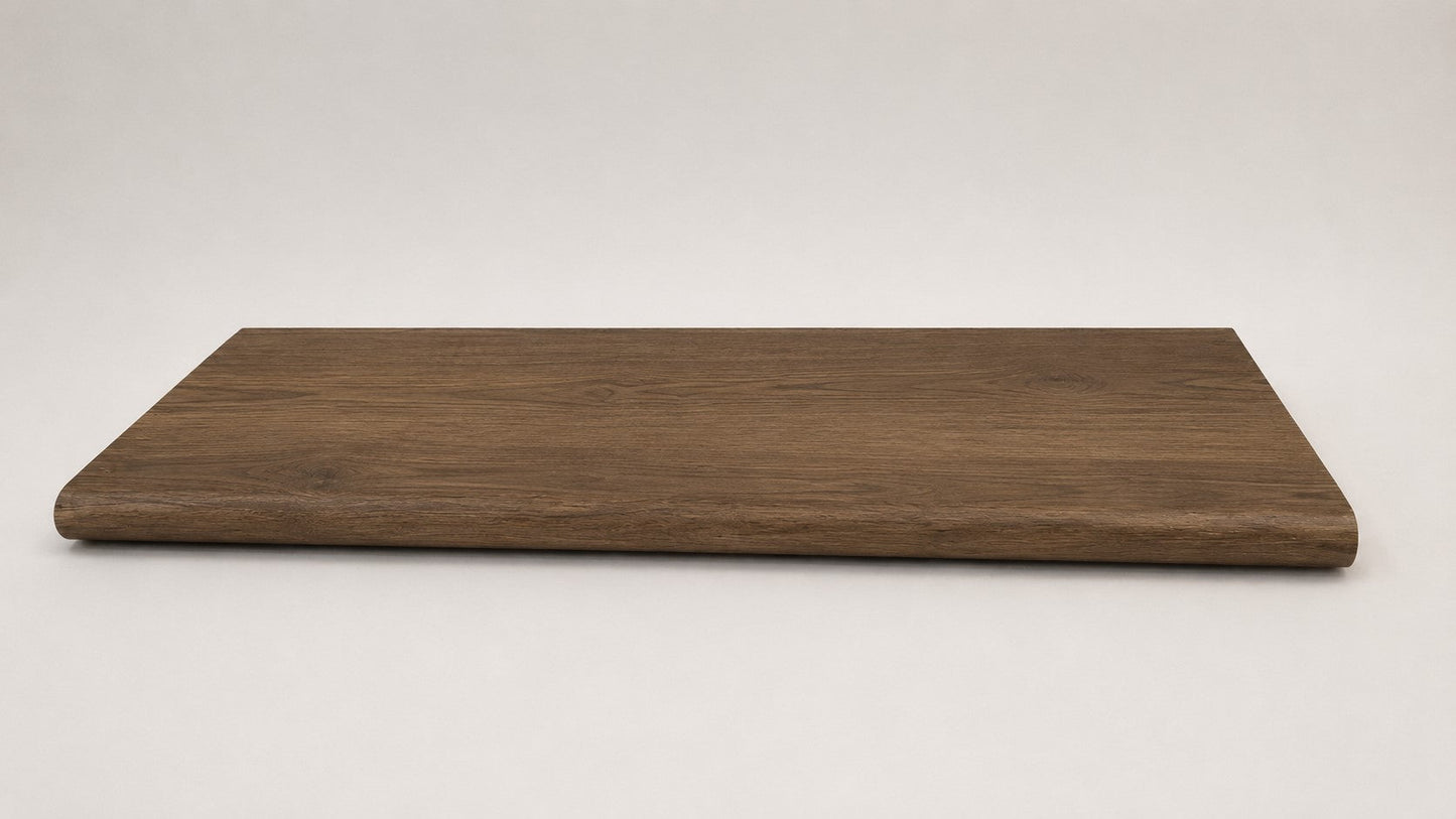 Custom round-nose stair tread made from Style Selections Tudor Oak flooring. Round profile. Full view.