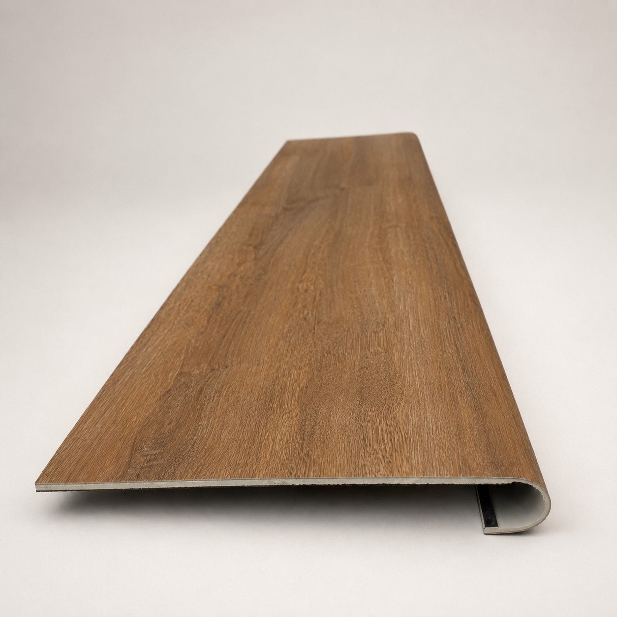 Custom round-nose stair tread made to match LifeProof Butler Hickory flooring. Round profile. Front view.