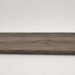 Custom round-nose stair tread made from DuraLux Performance Stormy Elm flooring. Round profile. Full view.